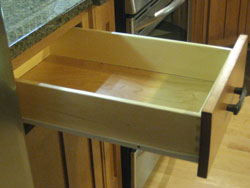 Side shot of an open kitchen drawer