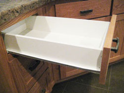 A white kitchen drawer open from the side