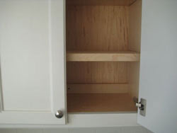 White wooden cabinets with one door open