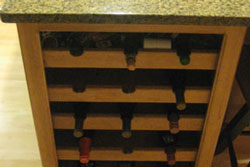 A wine storage rack with a grey spotted marble top