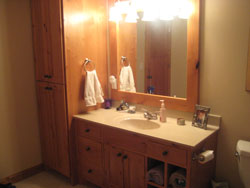 A bathroom sink with custom wood cabintry