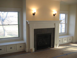 A dark gray fireplace with a white mantle