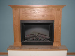 A black metal fireplace with a medium wood colored mantle