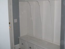 Custom white cabintry for shoe and coat storage
